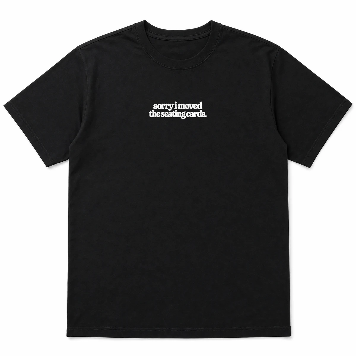 flat lay mockup of a heavyweight tee in black and white, front view, with the printed line sorry i moved the seating cards across the chest, Black front view