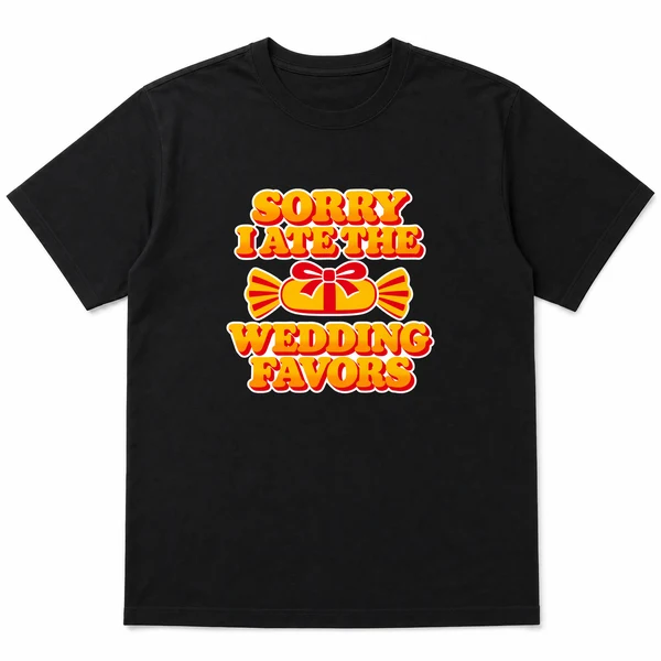 flat lay mockup of a heavyweight tee in black and white, front view, with the printed line SORRY I ATE THE / WEDDING FAVORS across the chest