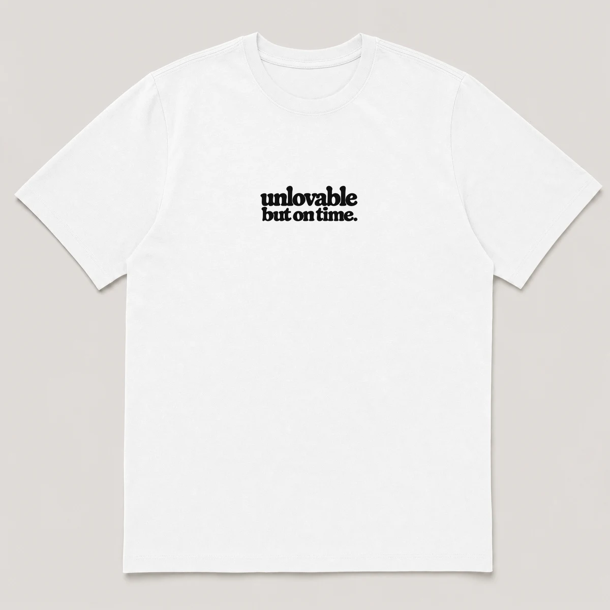 flat lay mockup of a heavyweight tee in black and white, front view, with the printed line unlovable but on time across the chest, White front view