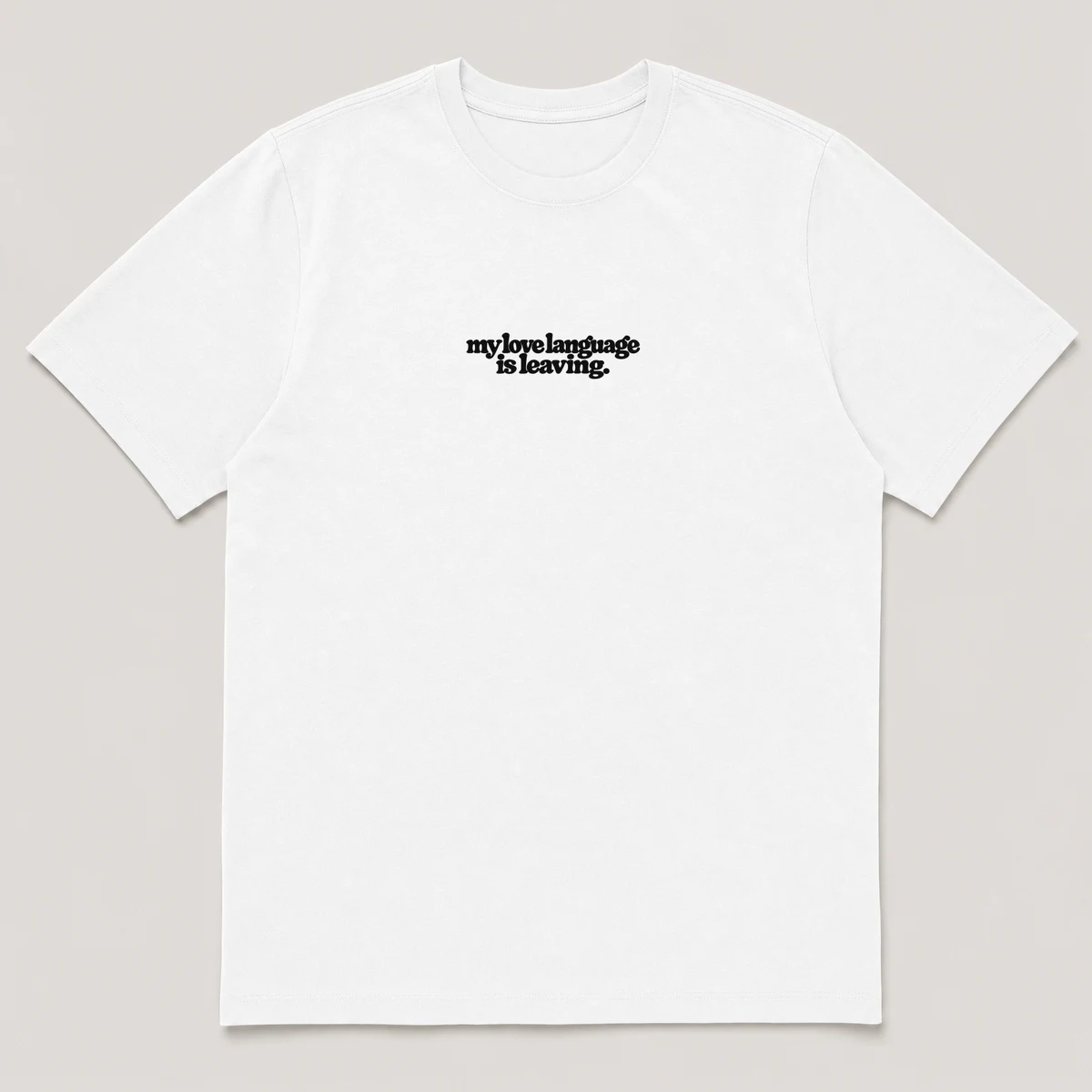 flat lay mockup of a heavyweight tee in black and white, front view, with the printed line my love language is leaving across the chest, White front view