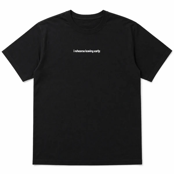 flat lay mockup of a heavyweight tee in black and white, front view, with the printed line i rehearse leaving early across the chest