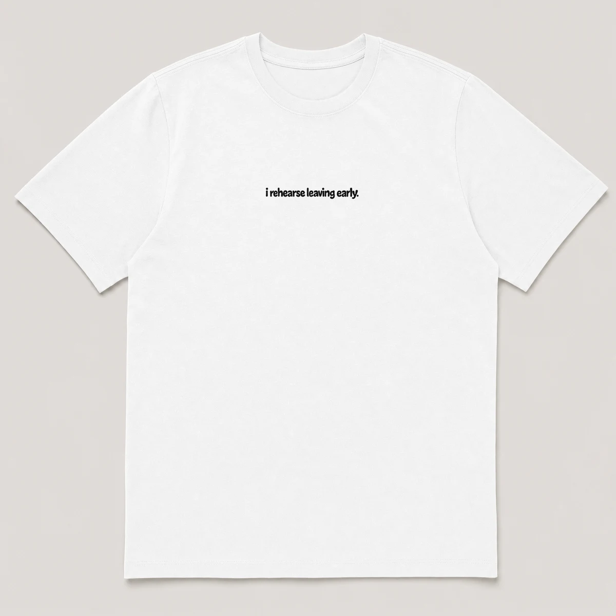 flat lay mockup of a heavyweight tee in black and white, front view, with the printed line i rehearse leaving early across the chest, White front view